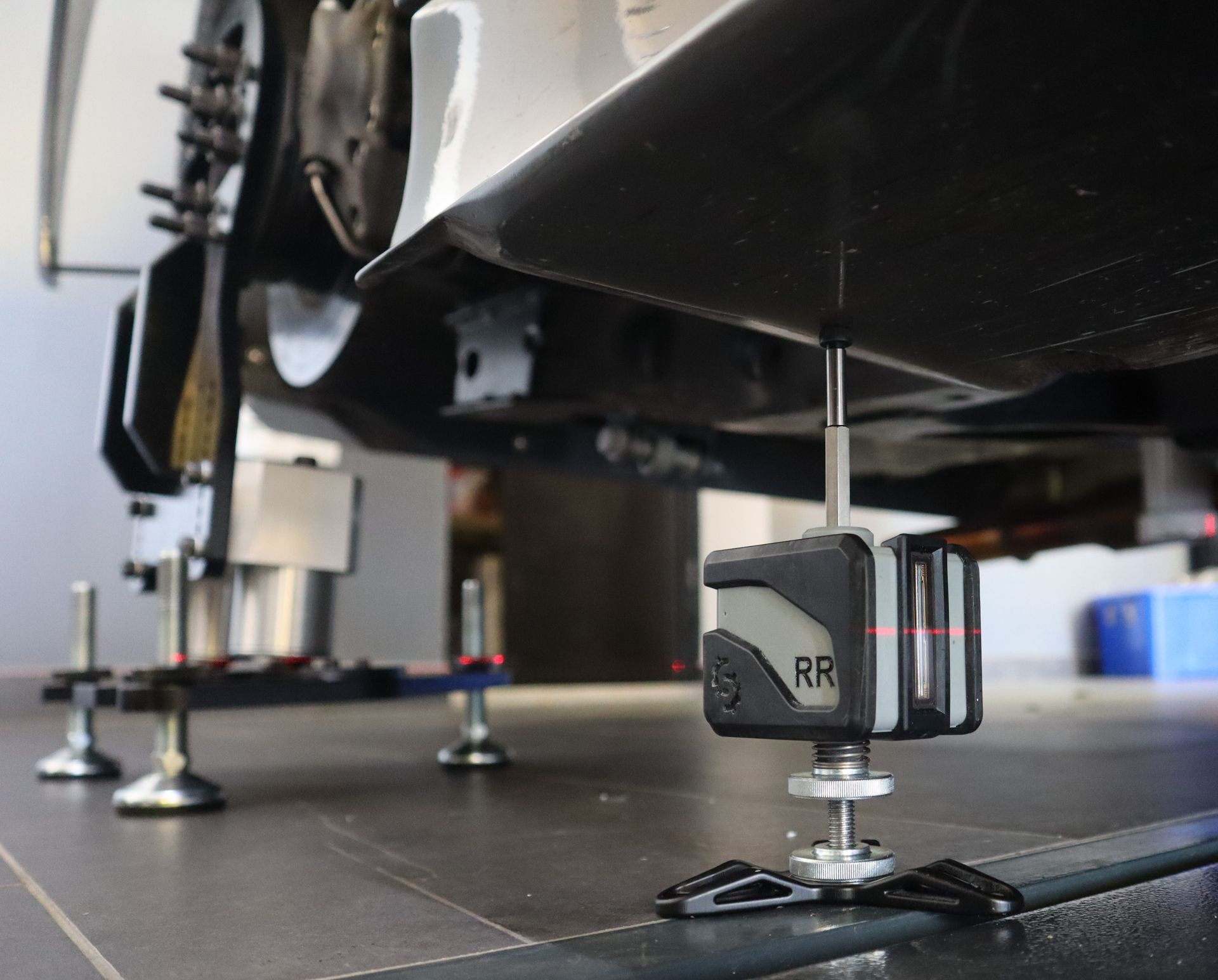 ToeGauge and HeightGauge mounted to the underside of a race car- motorsport wheel alignment and toe measurement equipment